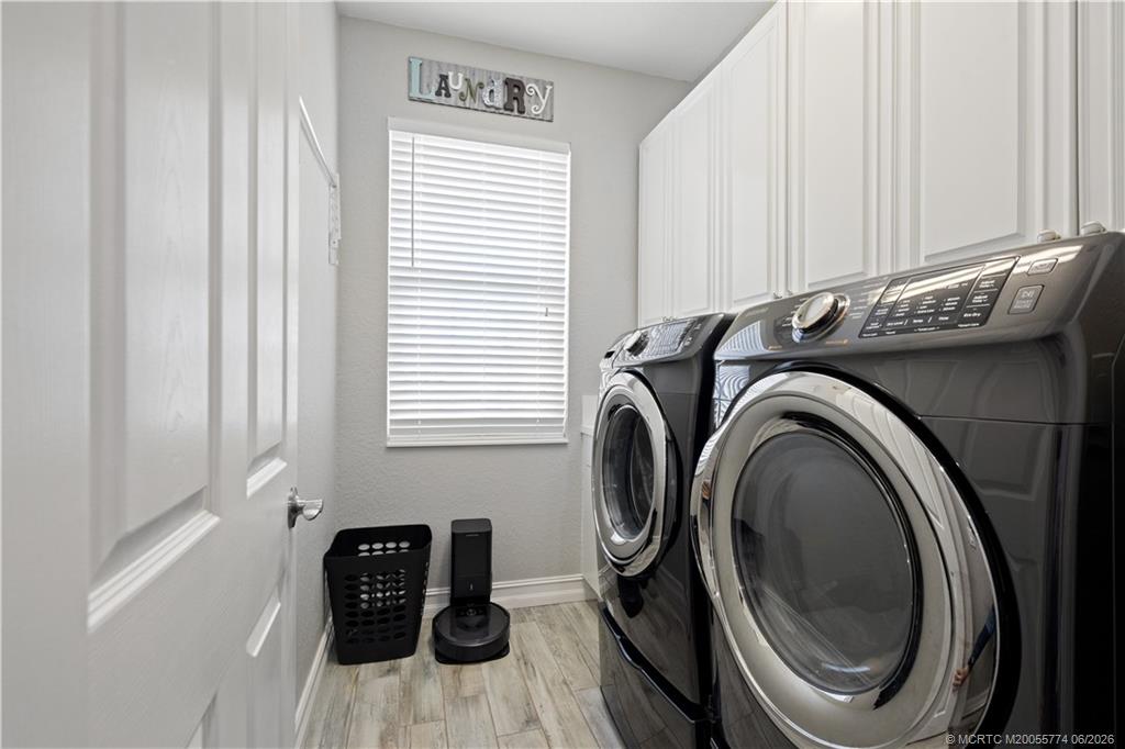 1268 Southeast Kirk Street Stuart, FL 34997 - Photo 45 of 63 a view of a storage and utility room with a washer dryer