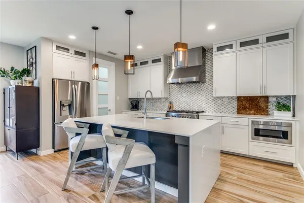 a kitchen with a sink cabinets and refrigerator