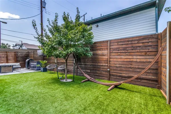 a backyard of a house with table and chairs