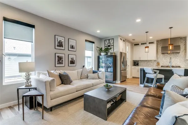 a living room with furniture and a view of kitchen