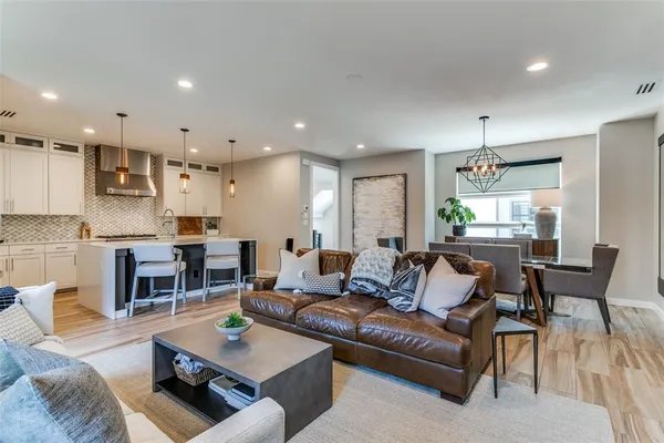 a living room with furniture kitchen view and a table