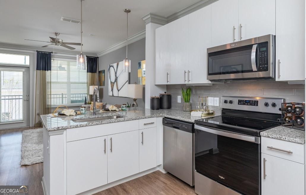 1486 Terrell Mill Road Southeast, Unit 449 Marietta, GA 30067 - Photo 1 of 25 a kitchen with a sink stove and microwave