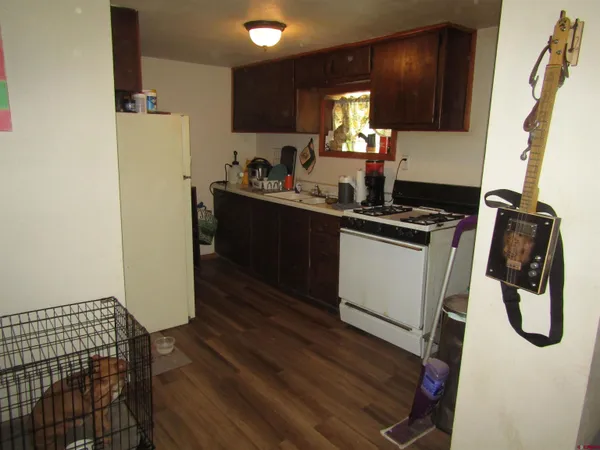 a kitchen with a refrigerator and a stove top oven