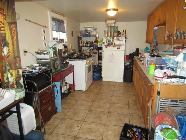a kitchen with stainless steel appliances kitchen island granite countertop a stove and a refrigerator