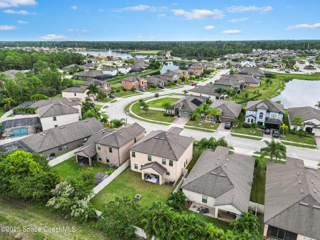 an aerial view of a house with a yard