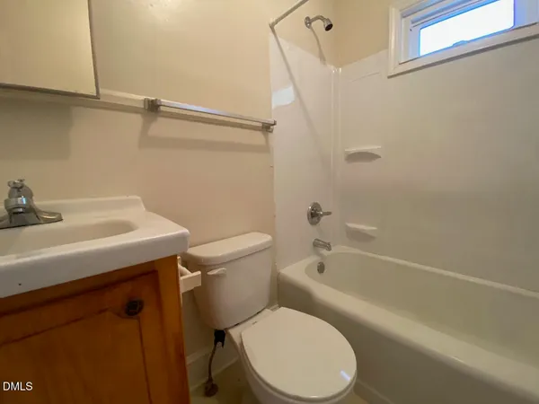 a white toilet sitting next to a bath tub