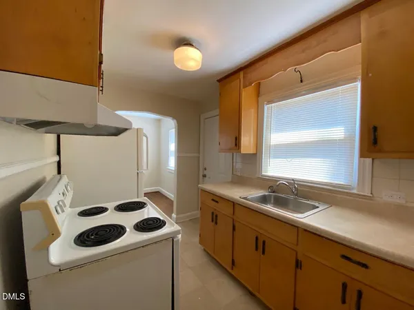 a kitchen that has a sink and a stove