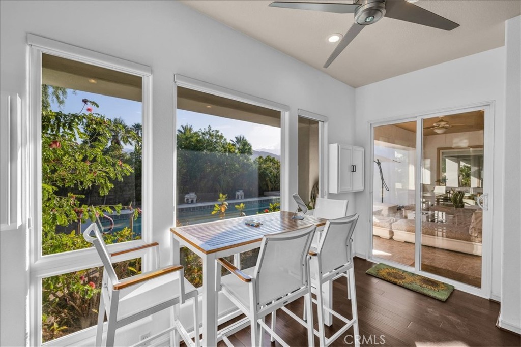 4 Oakmont Drive Rancho Mirage, CA 92270 - Photo 17 of 73 a view of a dining room with furniture large windows and wooden floor