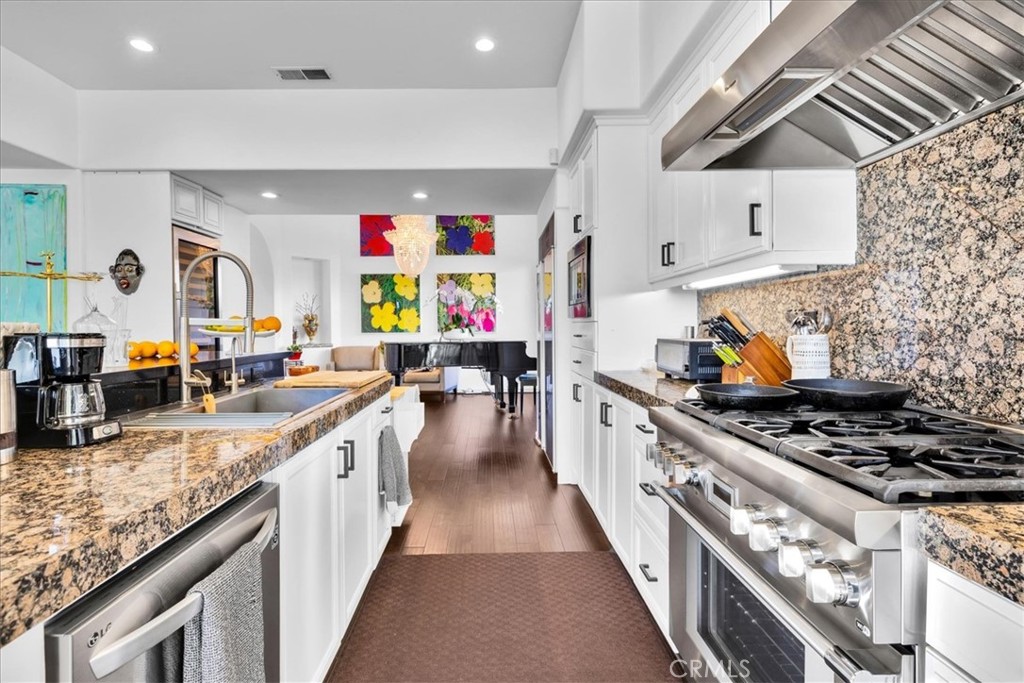 4 Oakmont Drive Rancho Mirage, CA 92270 - Photo 19 of 73 a kitchen with stainless steel appliances granite countertop a stove and a sink