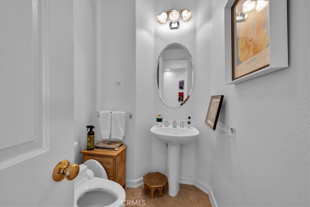 4 Oakmont Drive Rancho Mirage, CA 92270 - Photo 23 of 73 a bathroom with a sink and mirror with toilet