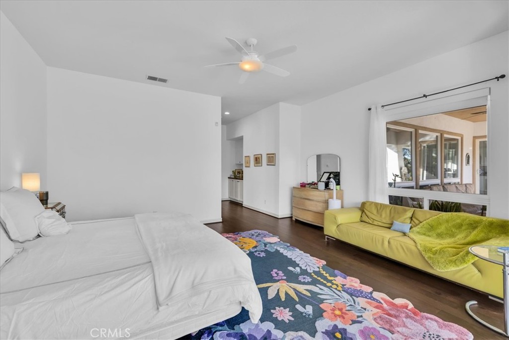 4 Oakmont Drive Rancho Mirage, CA 92270 - Photo 26 of 73 a bedroom with a couch and wooden floor