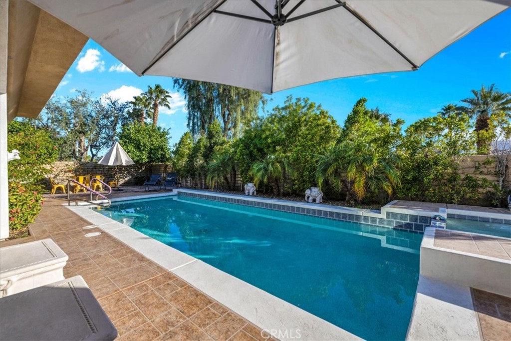 4 Oakmont Drive Rancho Mirage, CA 92270 - Photo 48 of 73 a view of a swimming pool with an outdoor space and seating area