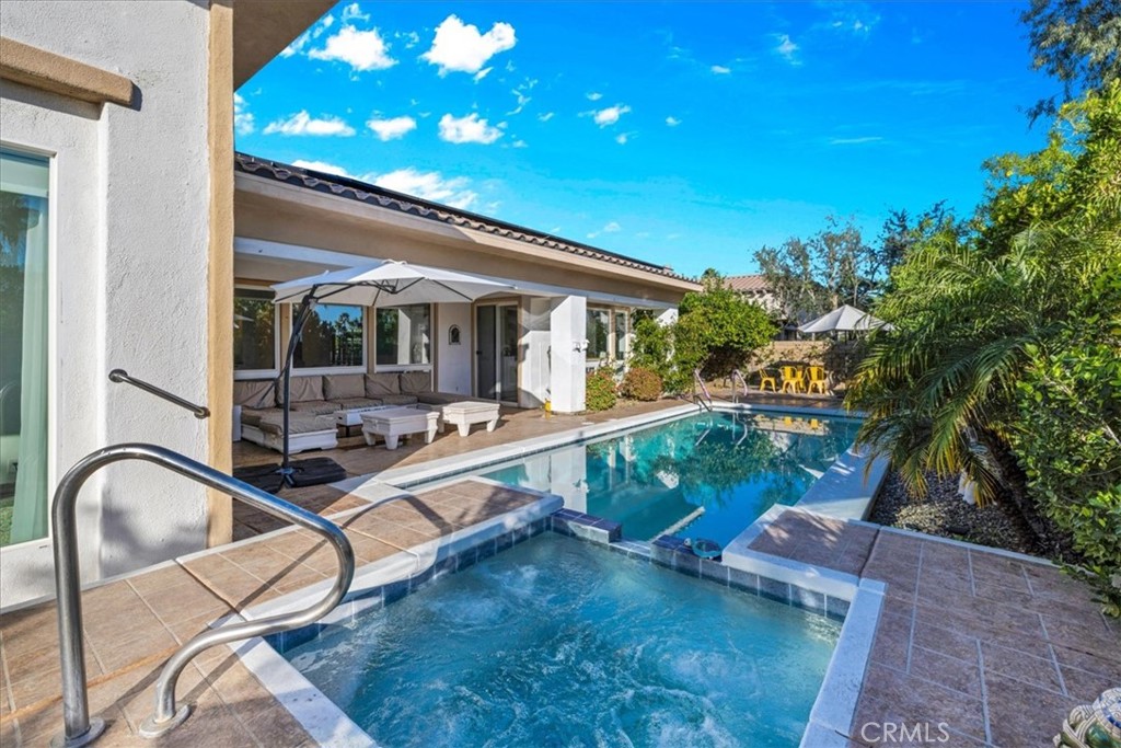 4 Oakmont Drive Rancho Mirage, CA 92270 - Photo 53 of 73 a view of a swimming pool with a patio and a yard