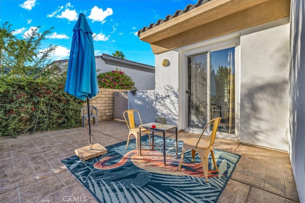 4 Oakmont Drive Rancho Mirage, CA 92270 - Photo 54 of 73 a view of a patio with table and chairs potted plants with wooden floor and fence