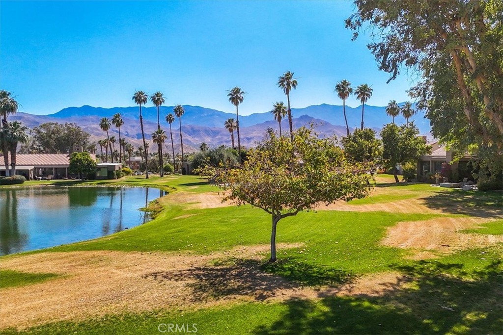 4 Oakmont Drive Rancho Mirage, CA 92270 - Photo 67 of 73 a view of a lake with a building in the background