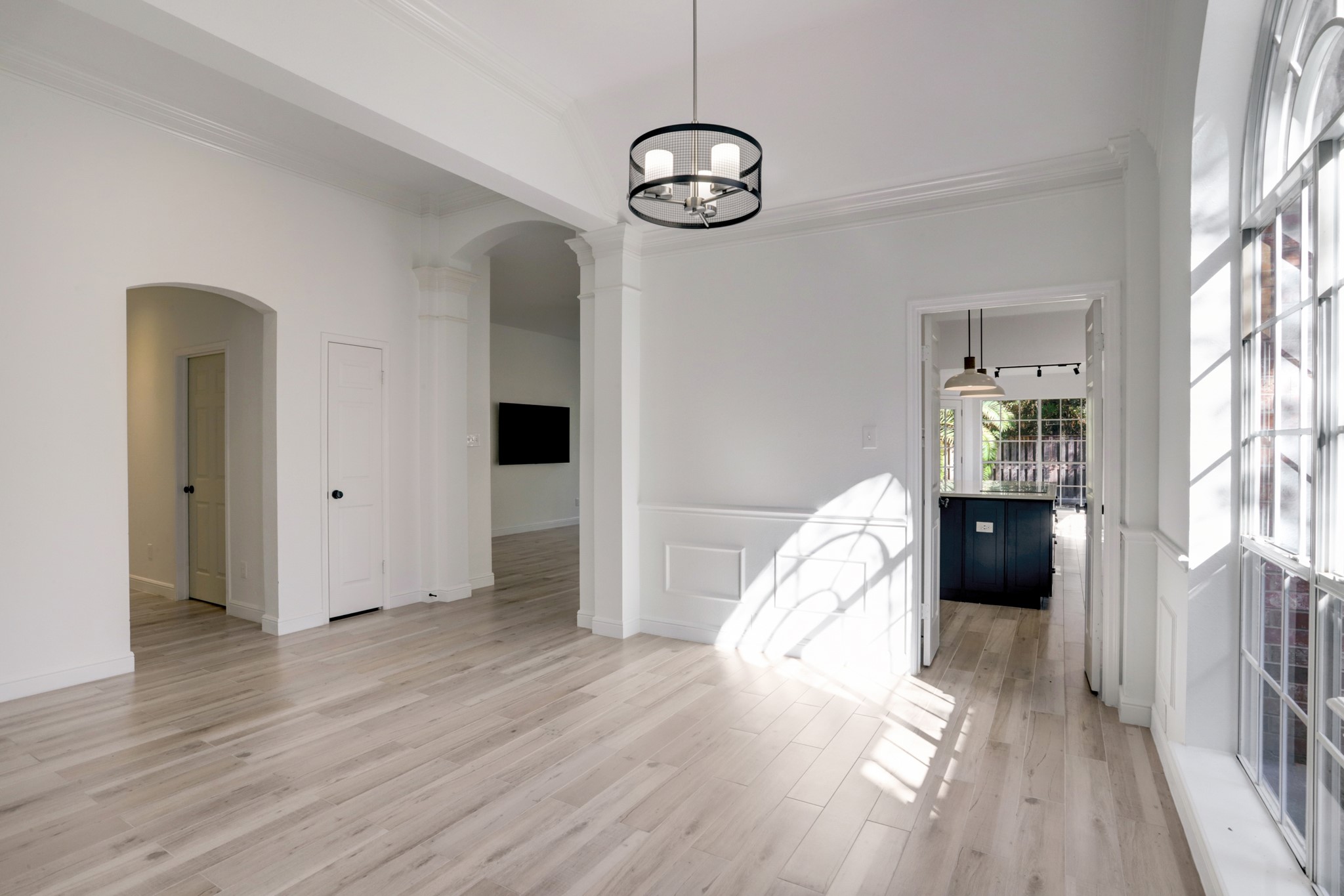 138 Summer Storm Place Spring, TX 77381 - Photo 5 of 20 Formal dining room featuring crown molding, architectural columns and an updated statement light fixture.