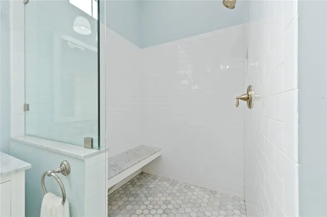 a bathroom with a sink a mirror and a shower