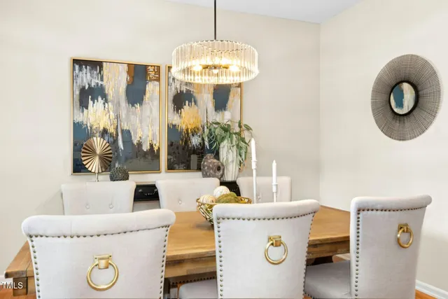 a living room with a table and a chandelier