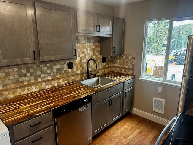 a kitchen with sink a window and appliances