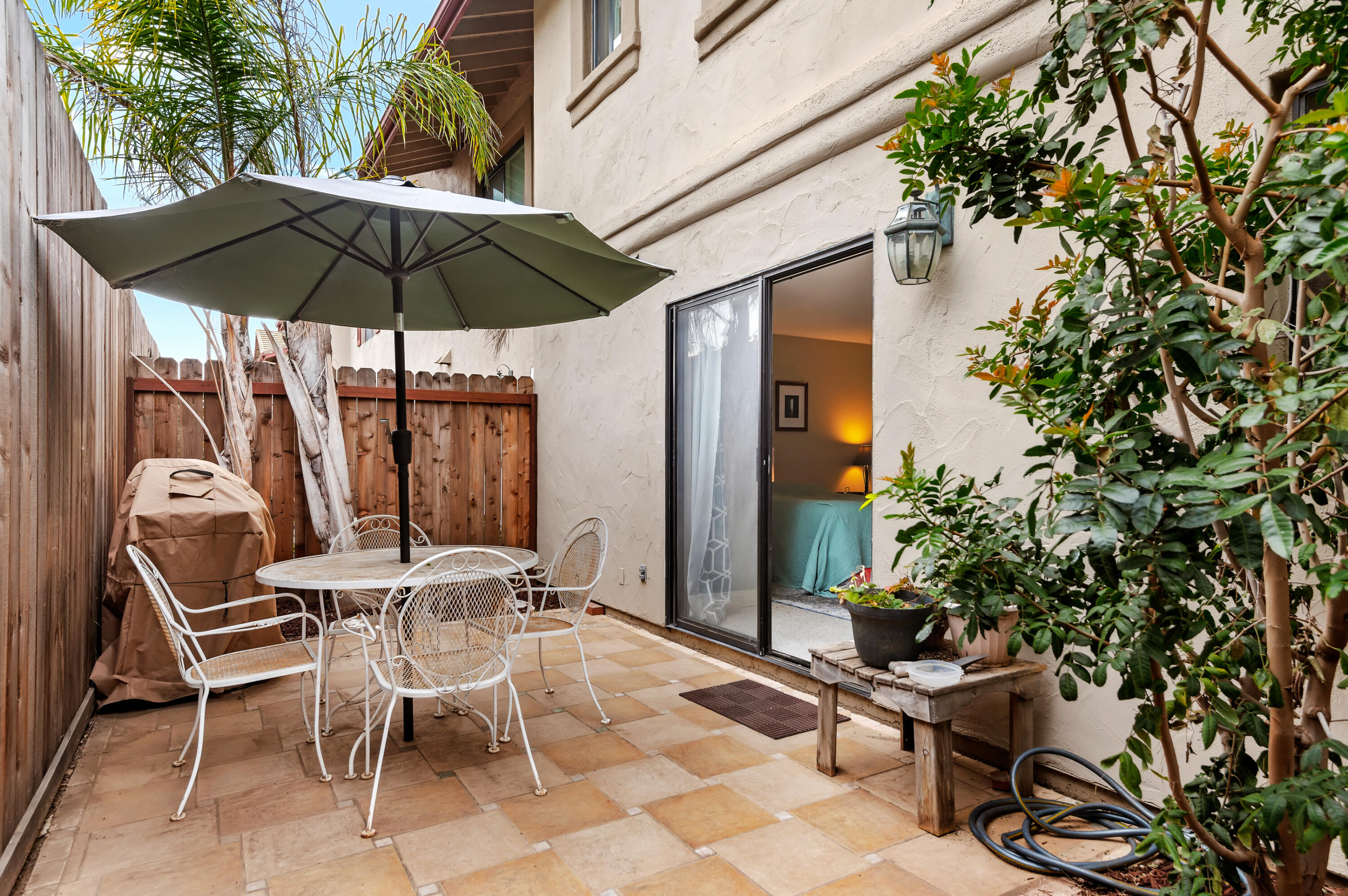 4344 Modoc Road, Unit 15 Santa Barbara, CA 93110 - Photo 17 of 19 a view of patio with chairs and table under an umbrella