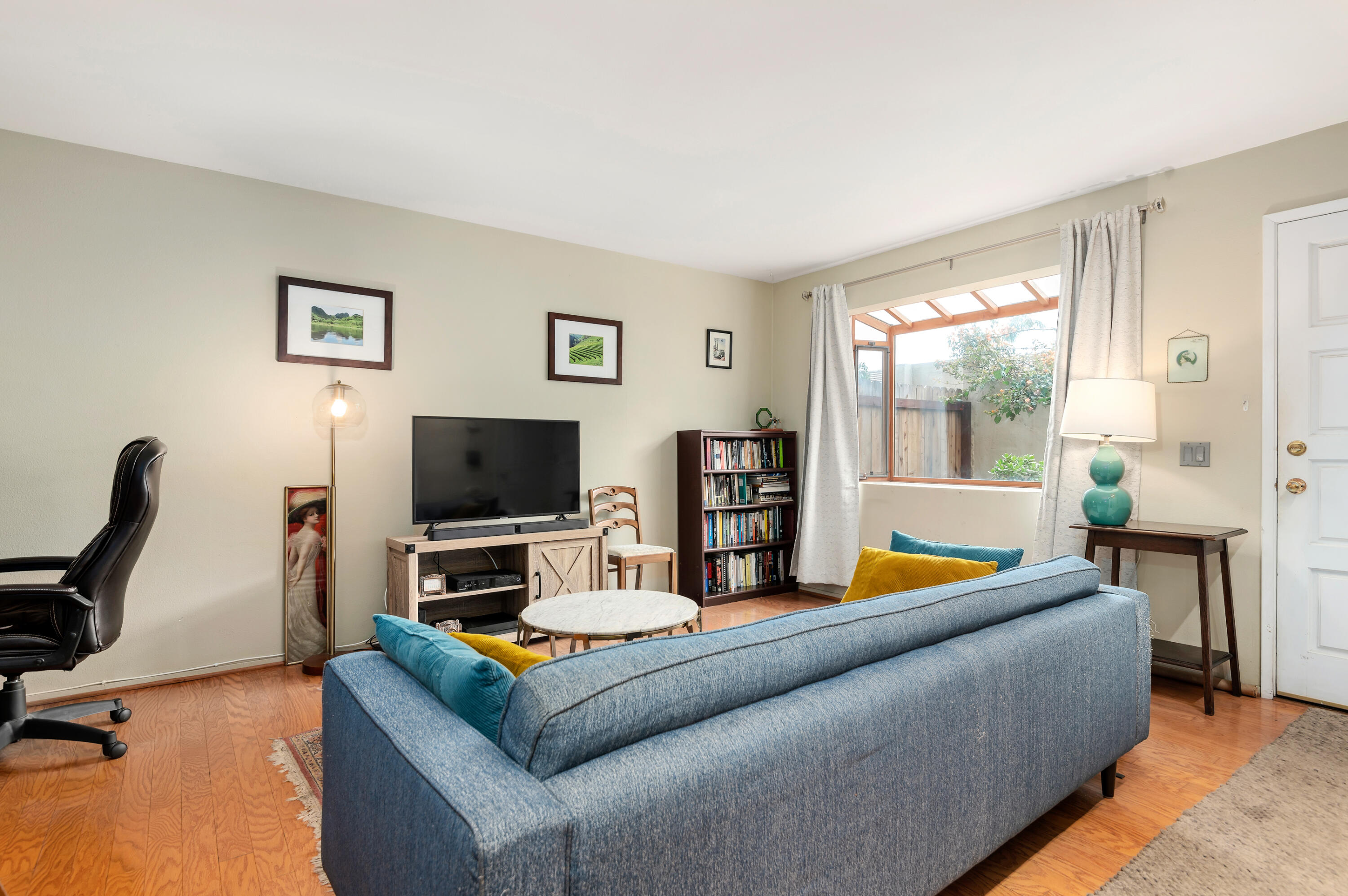 4344 Modoc Road, Unit 15 Santa Barbara, CA 93110 - Photo 5 of 19 a living room with furniture and a flat screen tv