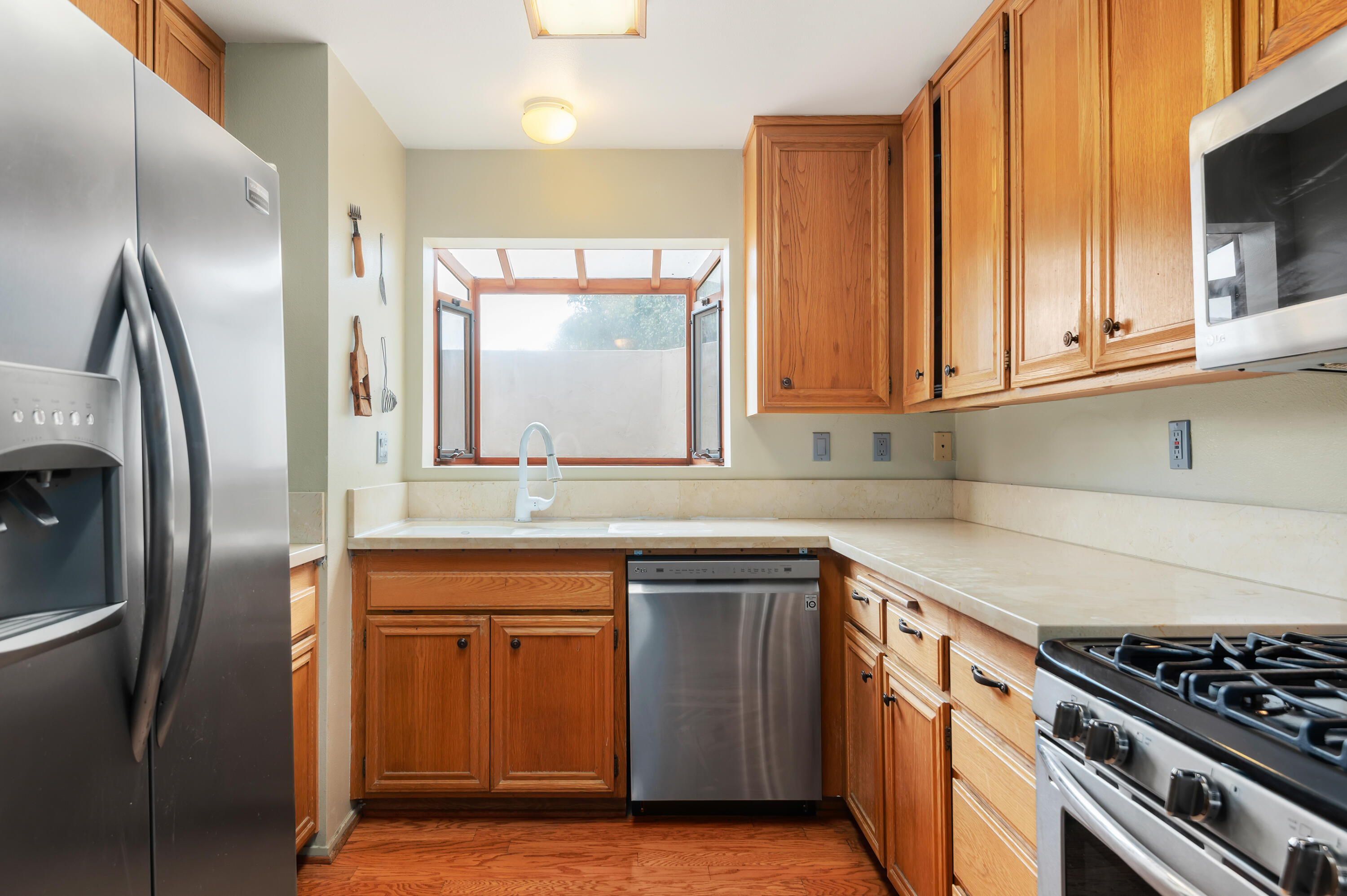 4344 Modoc Road, Unit 15 Santa Barbara, CA 93110 - Photo 6 of 19 a kitchen with stainless steel appliances granite countertop a sink stove and refrigerator