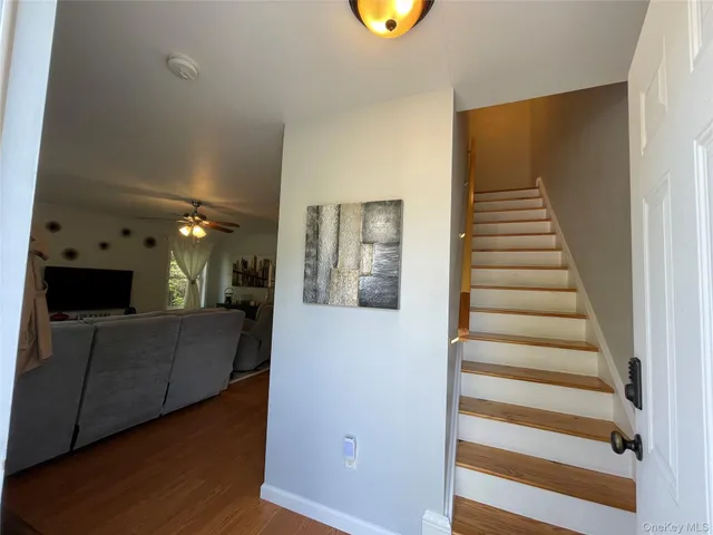 a view of a living room with furniture and wooden floor