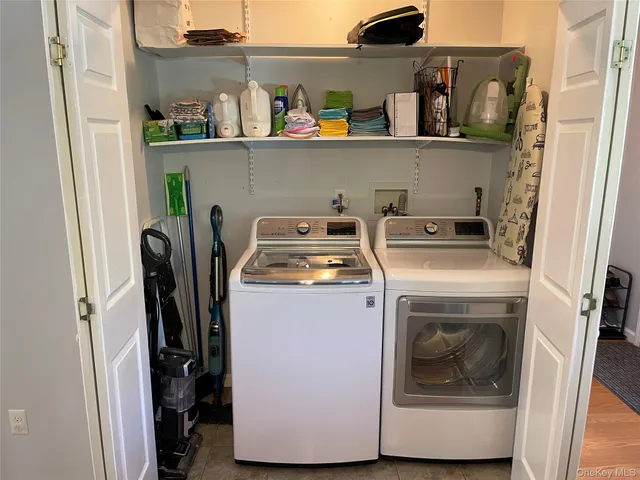 a utility room with sink dryer and washer