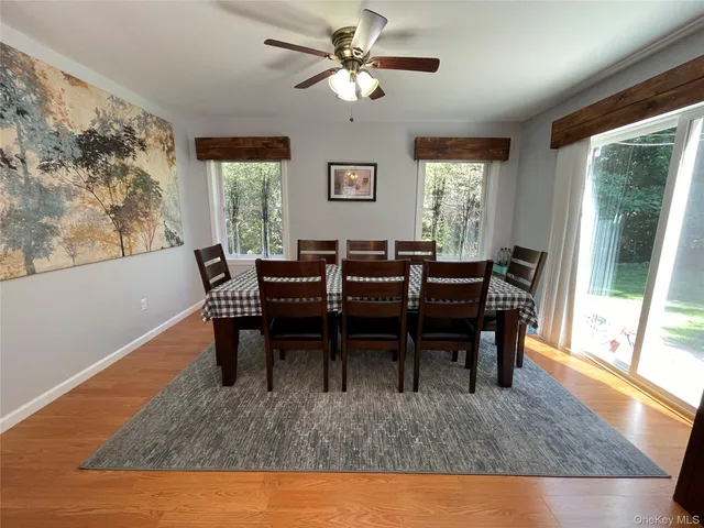a view of a dining room with furniture window and wooden floor