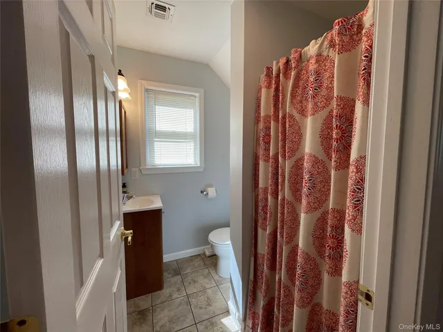 a bathroom with a shower and a toilet