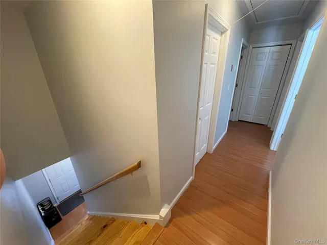 a view of a room with wooden floor