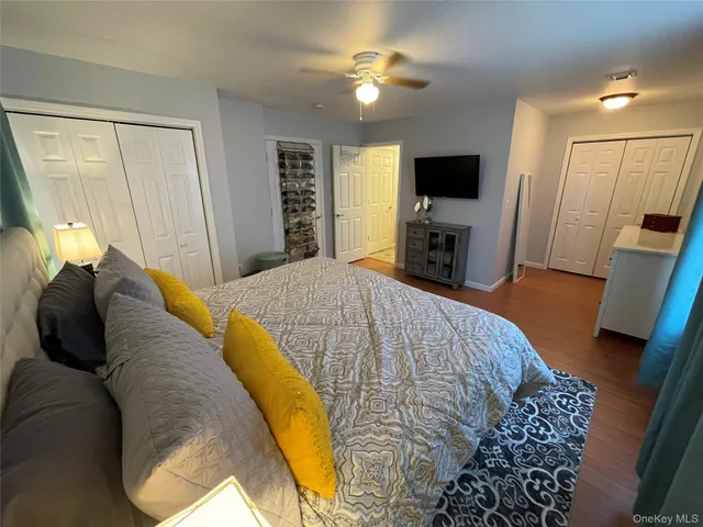 a spacious bedroom with a bed and a flat screen tv