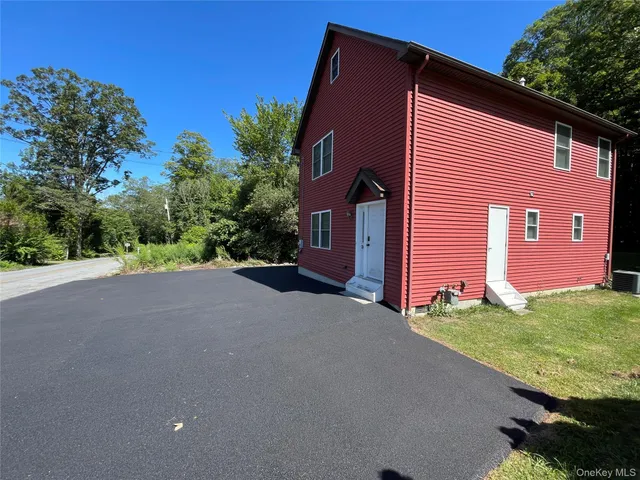 a view of a house with a yard and garage