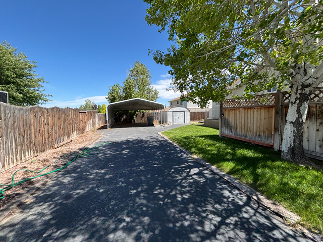 798 South 600 East Payson, UT 84651 - Photo 6 of 31 Paved driveway offering vehicle access, accompanied by a metal carport structure