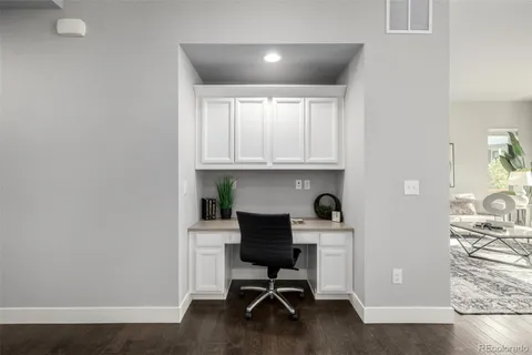 a workspace with furniture and wooden floor