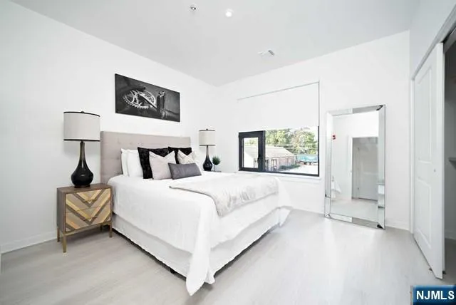 a bed room with a bed and a night stand