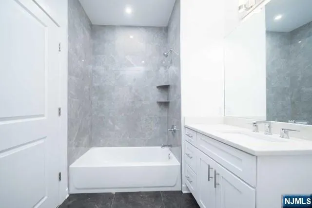 a bathroom with a bathtub and a sink