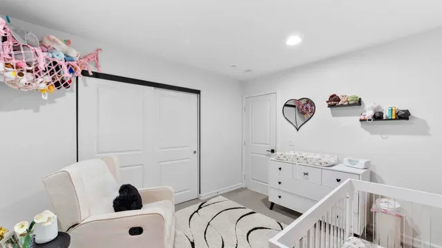 a bedroom with a bed and a white cabinet