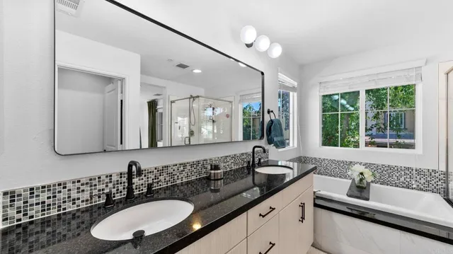 a bathroom with a double vanity sink and a mirror