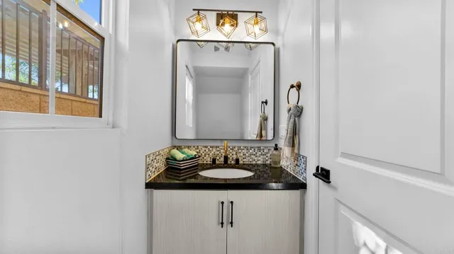 a bathroom with a sink and a mirror