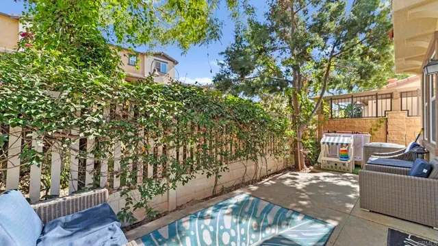 a view of a chairs and table in the back yard