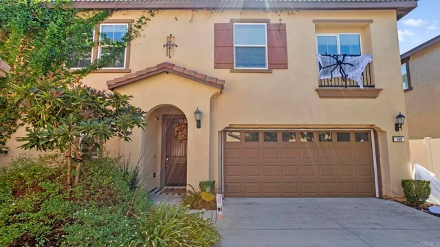a view of a house with a yard and sitting area
