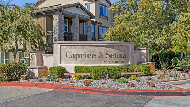 a swimming pool view with a seating space and a garden view