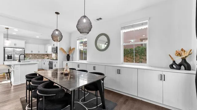 a kitchen with a table and chairs