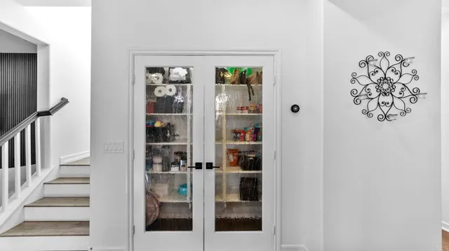 a view of a hallway with wooden floor and entryway