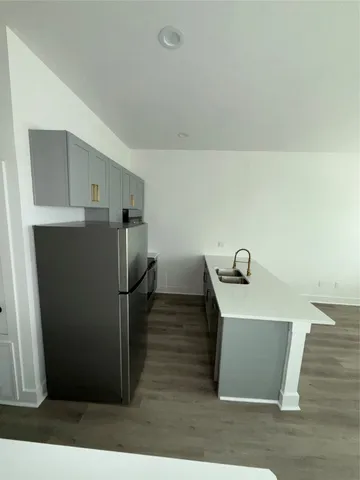 a view of a kitchen with cabinets and refrigerator