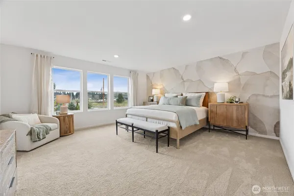 a spacious bedroom with a bed and a large window