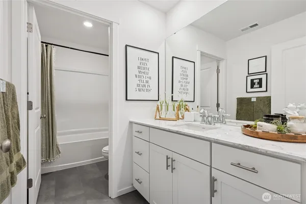 a bathroom with a double vanity sink mirror and shower