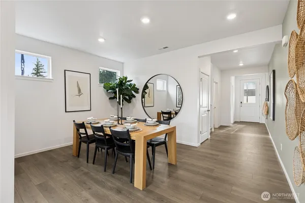 a view of a dining room with furniture and wooden floor