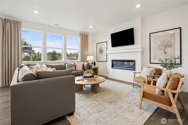 a living room with furniture fireplace and window